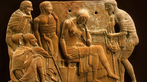 An ancient Greek teracotta plaque, depicting Odysseus returning to Penelope