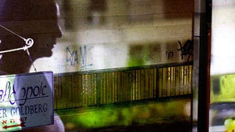 abstract image with hebrew writing, silhouette, and camera