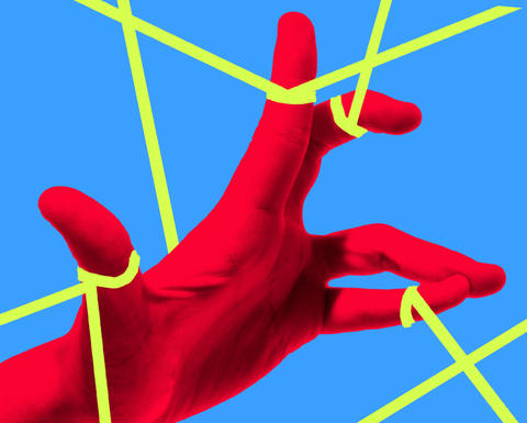 A red hand with yellow string wrapped around the fingers on a blue background