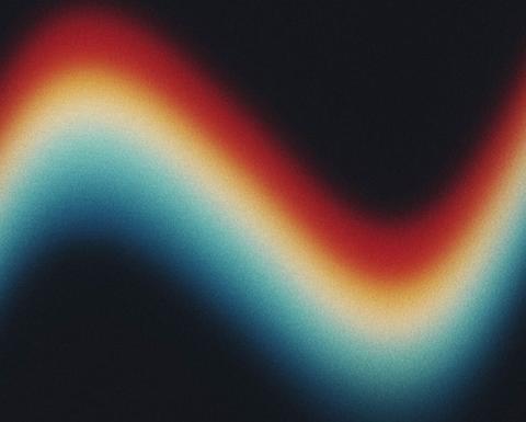 An abstract wave with red, yellow, and blue, on a black background