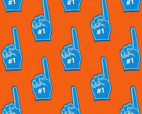 Blue foam fingers with "#1" printed on them against an orange background